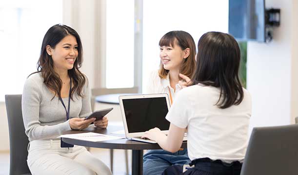 オフィスで会話しているスペイン人と日本人の女性